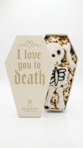 Spicy pickle marshmallow skeleton in coffin filled with kettle corn.